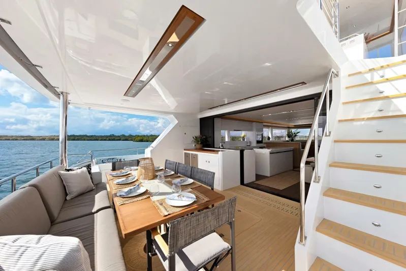 62 Iliad 2026 Yacht Photos Pics Luxurious ILIAD 62 yacht interior with dining area, modern kitchen, and scenic ocean view, 2026 model.