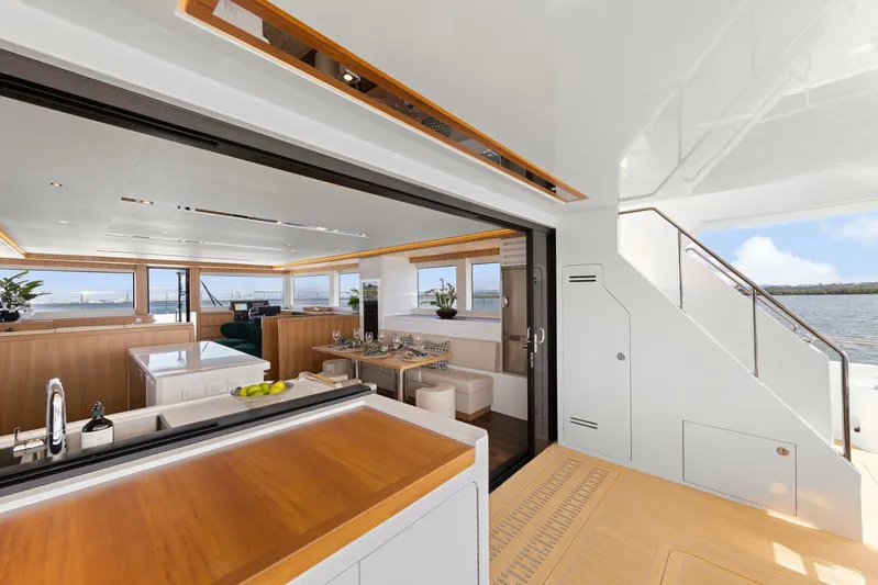 62 Iliad 2026 Yacht Photos Pics Luxurious interior of 2026 ILIAD 62 yacht with modern kitchen and dining area.