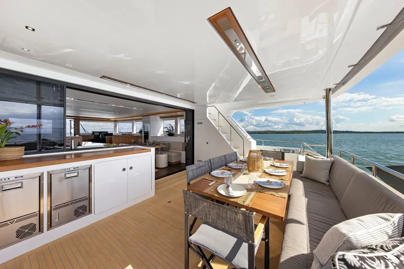 62 Iliad 2026 Yacht Photos Pics Luxurious 2026 ILIAD 62 yacht interior with elegant dining area and ocean view.
