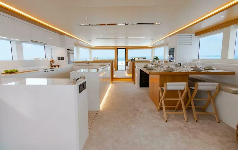 62 Iliad 2026 Yacht Photos Pics Luxurious interior of 2026 ILIAD 62 yacht with modern kitchen and dining area.