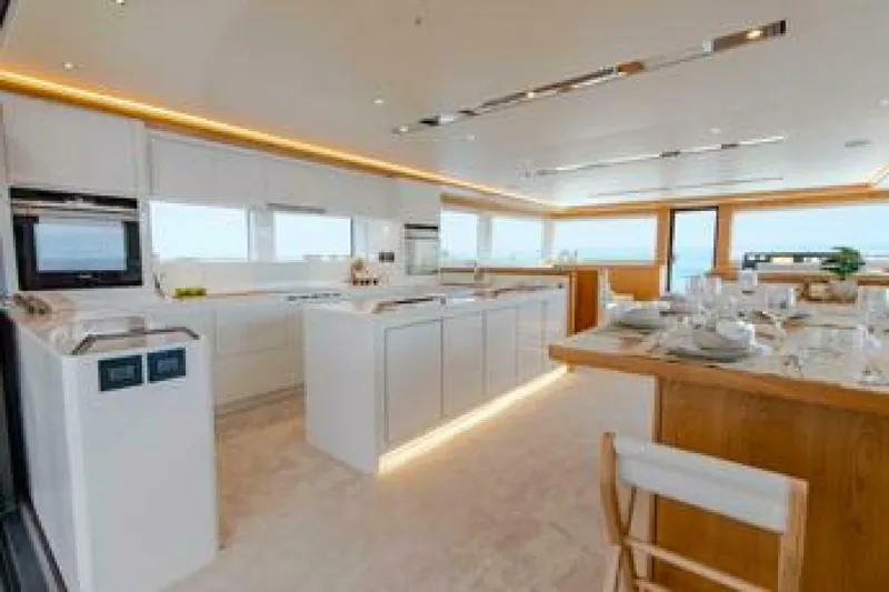 62 Iliad 2026 Yacht Photos Pics Luxurious kitchen interior on ILIAD 62 yacht, 2026 model, featuring modern design and elegant dining area.