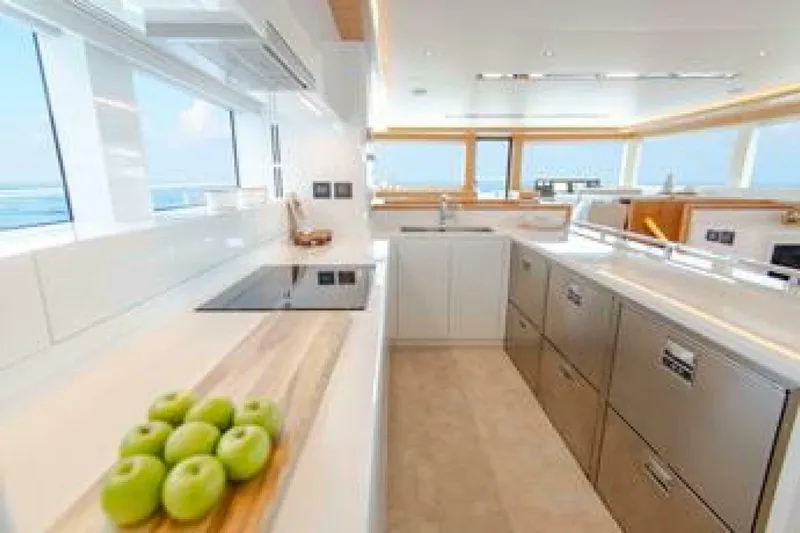 62 Iliad 2026 Yacht Photos Pics Luxurious kitchen interior on ILIAD 62 yacht, featuring modern appliances and green apples, 2026 model.