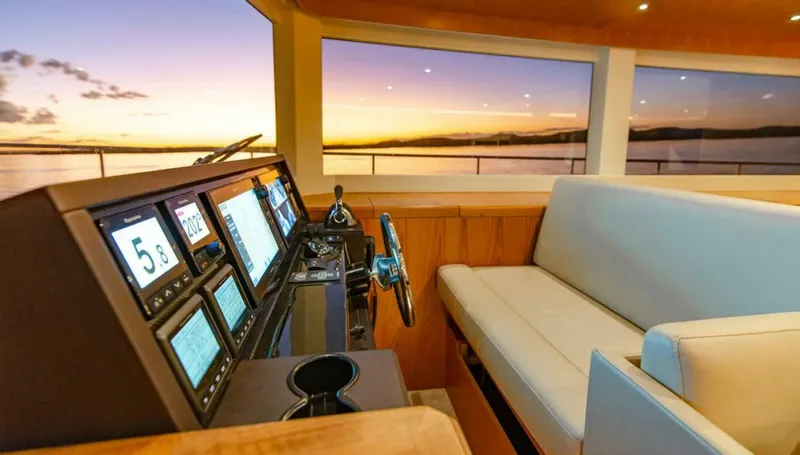 62 Iliad 2026 Yacht Photos Pics Luxurious ILIAD 62 yacht interior with modern navigation system, sunset view, and comfortable seating, 2026 model.