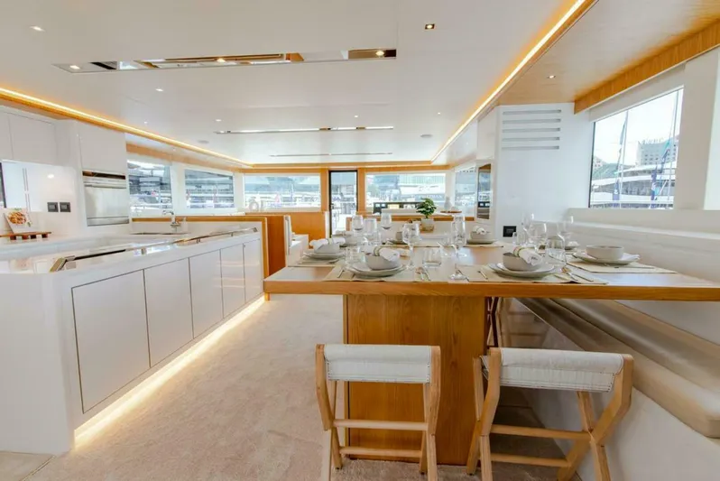 62 Iliad 2026 Yacht Photos Pics Luxurious interior of 2026 ILIAD 62 yacht with modern kitchen and dining area.