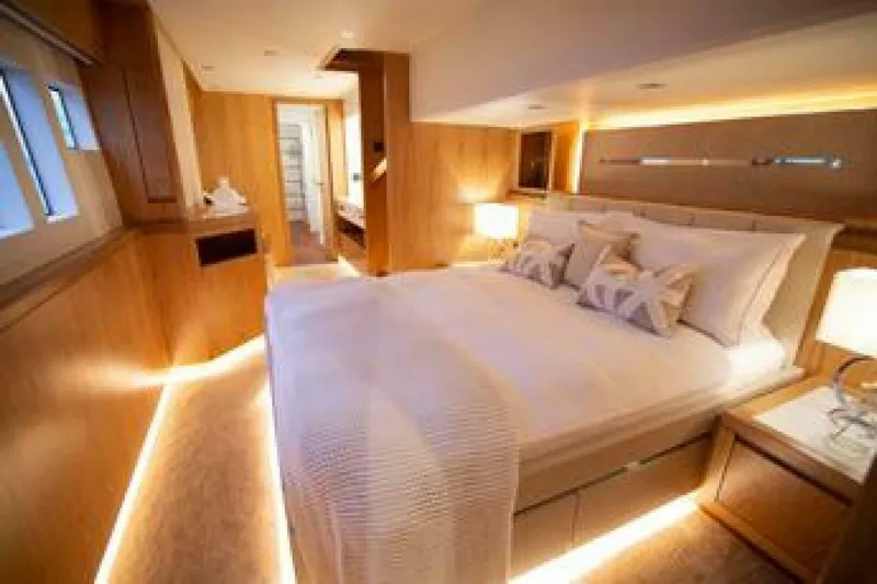 62 Iliad 2026 Yacht Photos Pics Luxurious bedroom interior on 2026 ILIAD 62 yacht, featuring elegant lighting and modern design.