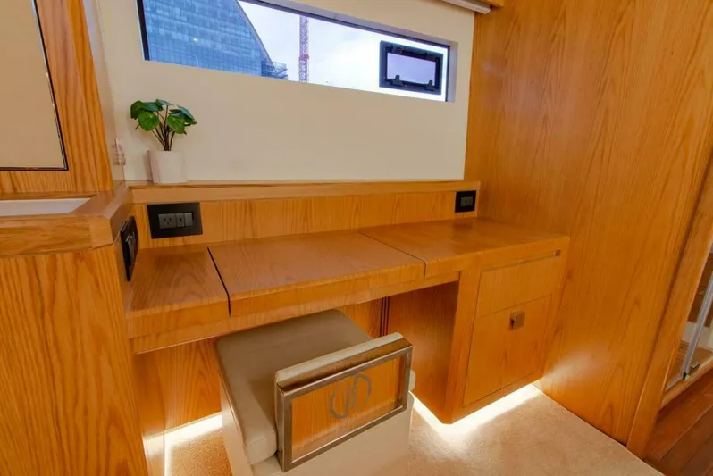 62 Iliad 2026 Yacht Photos Pics Luxurious wooden interior of ILIAD 62 yacht, featuring a sleek desk and modern design elements.