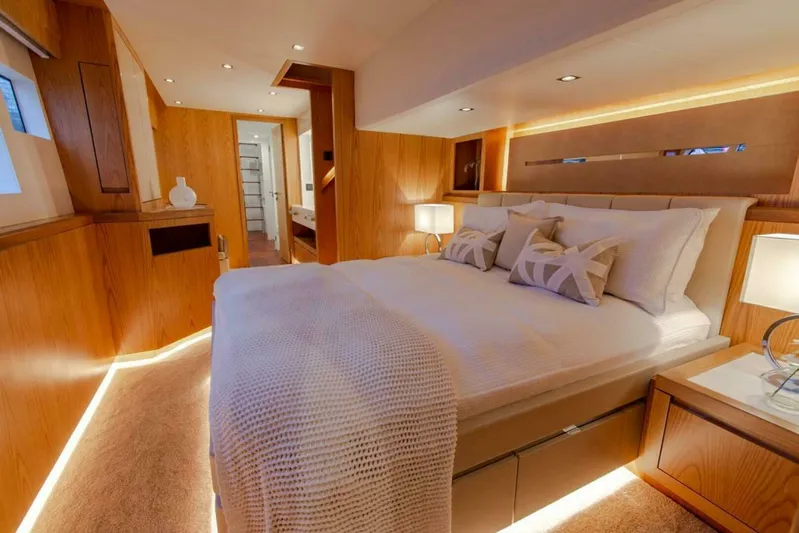 62 Iliad 2026 Yacht Photos Pics Luxurious bedroom interior on 2026 ILIAD 62 yacht, featuring elegant wood finishes and ambient lighting.