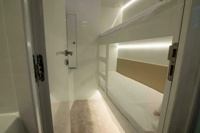 62 Iliad 2026 Yacht Photos Pics Compact bunk bed cabin in a 2026 ILIAD 62 yacht, featuring modern lighting and sleek design.