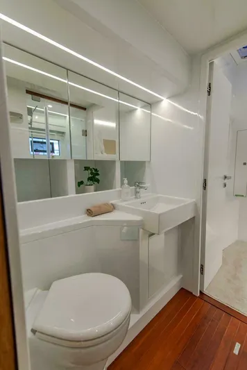 62 Iliad 2026 Yacht Photos Pics Modern yacht bathroom with sleek design, featuring a mirror, sink, and toilet. ILIAD 62, 2026 model.
