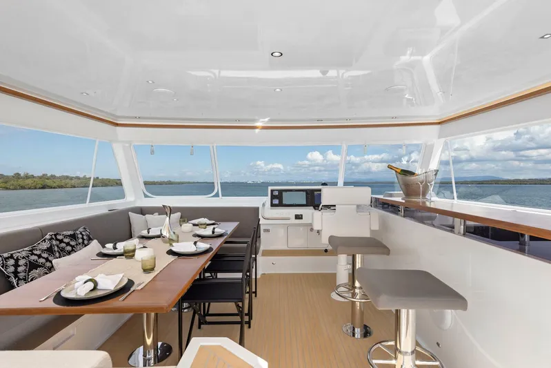 62 Iliad 2026 Yacht Photos Pics Luxurious interior of 2026 ILIAD 62 yacht with dining area and ocean view.