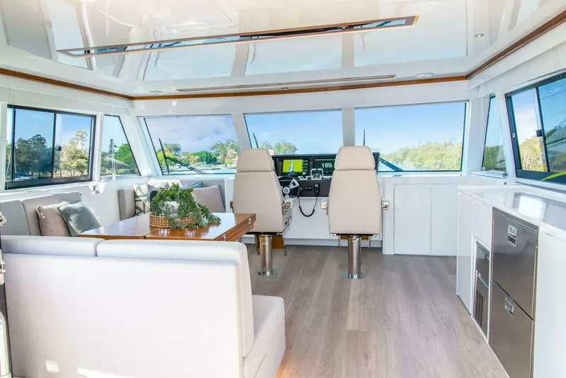 62 Iliad 2026 Yacht Photos Pics Luxurious interior of 2026 ILIAD 62 yacht with modern seating and navigation area.