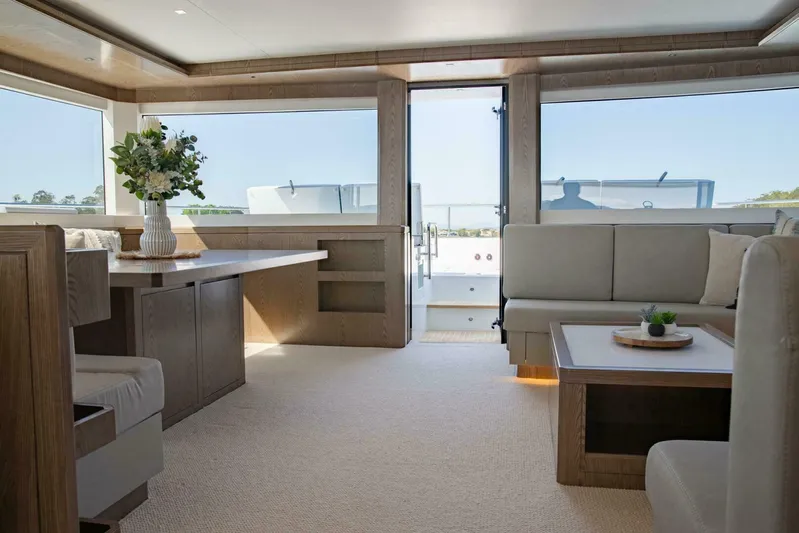 62 Iliad 2026 Yacht Photos Pics Luxurious interior of 2026 ILIAD 62 yacht with modern furnishings and large windows.