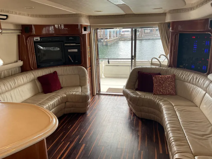  Yacht Photos Pics Luxurious interior of a 1999 Sea Ray 560 Sedan Bridge yacht with leather seating and wood flooring.