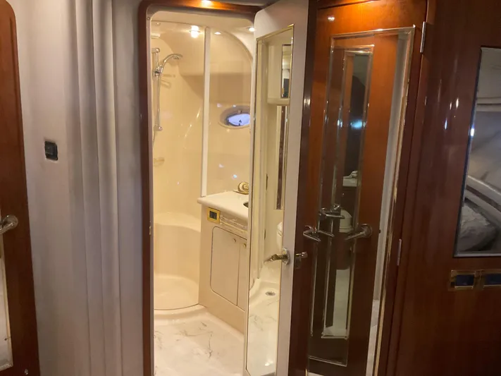  Yacht Photos Pics 1999 Sea Ray 560 Sedan Bridge yacht interior with elegant bathroom and wooden finishes.