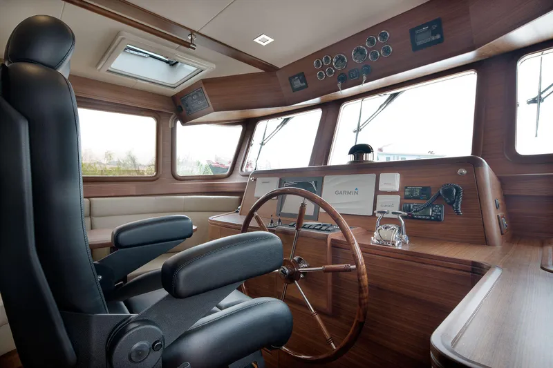  Yacht Photos Pics Interior of 2026 Selene 72 Explorer yacht cockpit with steering wheel and navigation equipment.