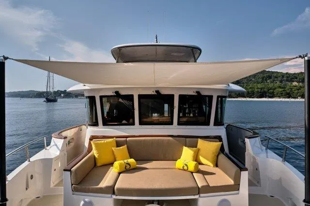  Yacht Photos Pics Luxurious Selene 72 Explorer yacht with sunshade and yellow cushions, 2026 model, on serene water.