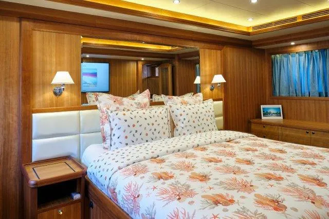  Yacht Photos Pics Luxurious bedroom interior on Selene 72 Explorer yacht, 2026 model, with elegant wood paneling.