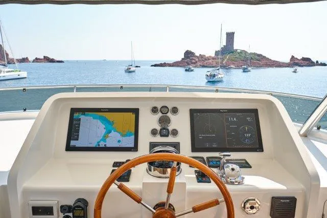 Yacht Photos Pics Helm of 2026 Selene 72 Explorer yacht with navigation screens, overlooking a scenic island.