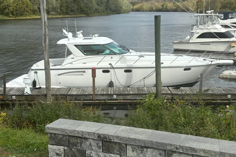 Radio Flyer Yacht Photos Pics 2005 Tiara Yachts 4400 Sovran docked on a serene river.