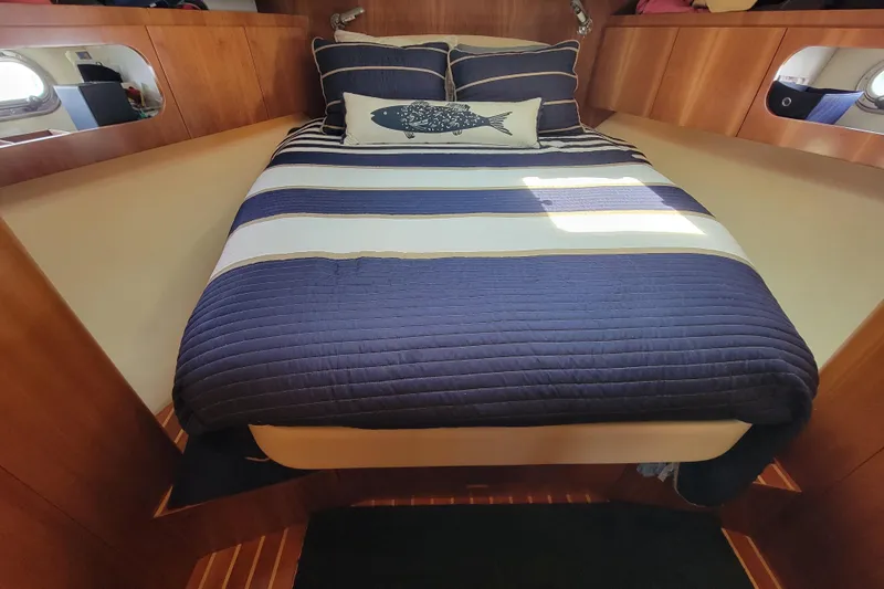 Radio Flyer Yacht Photos Pics Luxurious cabin interior of 2005 Tiara Yachts 4400 Sovran with striped bedding.