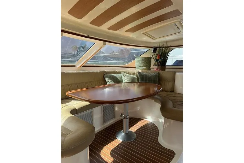Sea Angel Yacht Photos Pics Luxurious interior of 2007 Africat Marine 420 yacht with elegant seating and wooden table.