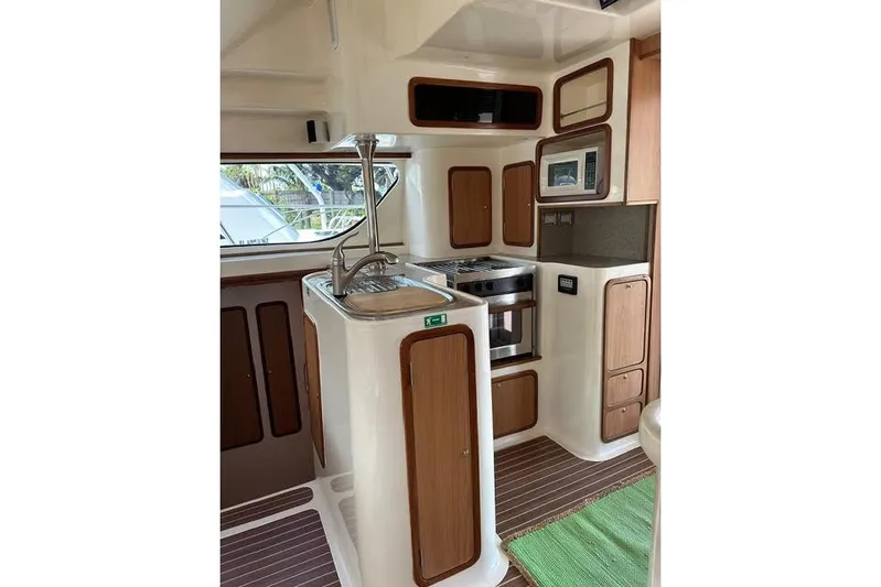 Sea Angel Yacht Photos Pics 2007 Africat Marine 420 yacht interior with modern kitchen and wooden cabinetry.