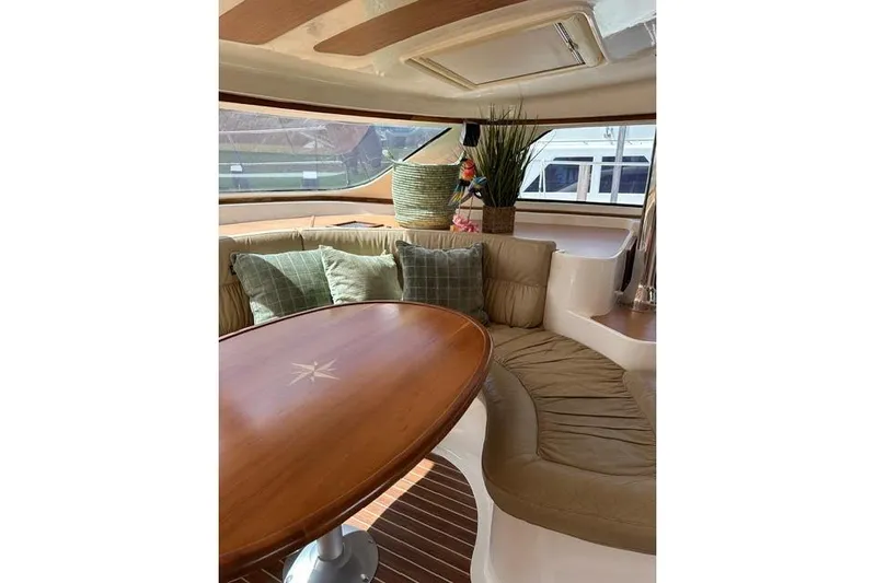 Sea Angel Yacht Photos Pics Luxurious interior of 2007 Africat Marine 420 yacht with elegant seating and wooden table.