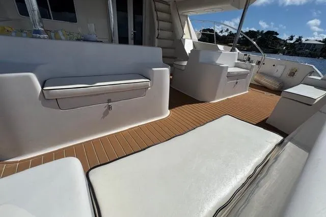 Sea Angel Yacht Photos Pics Luxurious 2007 Africat Marine 420 yacht deck with white seating and wooden flooring.