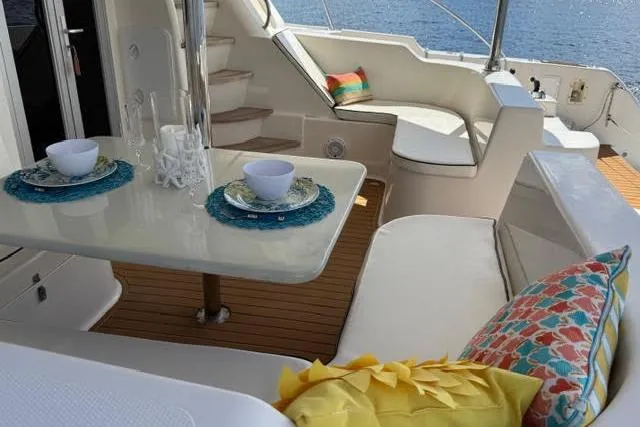 Sea Angel Yacht Photos Pics Luxurious 2007 Africat Marine 420 yacht interior with elegant dining setup and colorful cushions.