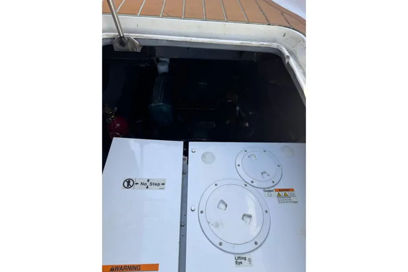 Sea Angel Yacht Photos Pics Engine compartment of 2007 Africat Marine 420 boat with safety warnings visible.