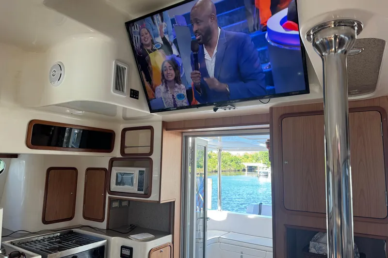 Sea Angel Yacht Photos Pics Interior of 2007 Africat Marine 420 yacht with TV and kitchen area.