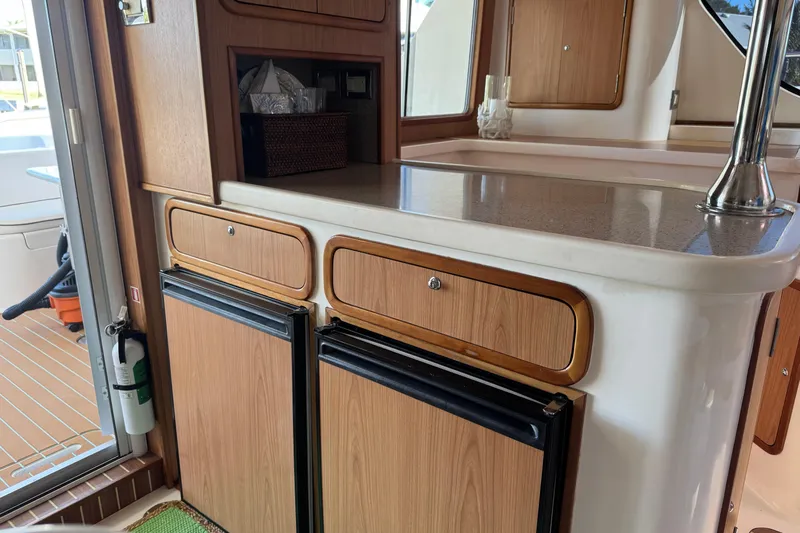 Sea Angel Yacht Photos Pics Interior of 2007 Africat Marine 420 yacht with wooden cabinetry and compact appliances.