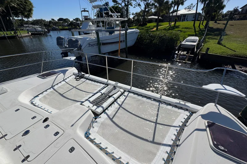Sea Angel Yacht Photos Pics 2007 Africat Marine 420 catamaran docked in a sunny marina with lush greenery.
