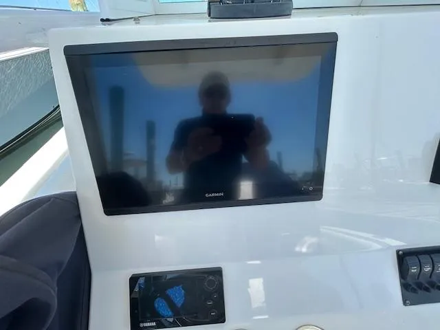  Yacht Photos Pics Garmin display on 2013 Regulator 26 FS boat dashboard with reflection.