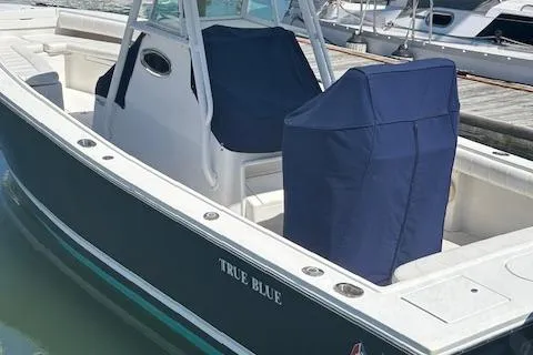  Yacht Photos Pics 2013 Regulator 26 FS boat named "True Blue" docked with covered seats.