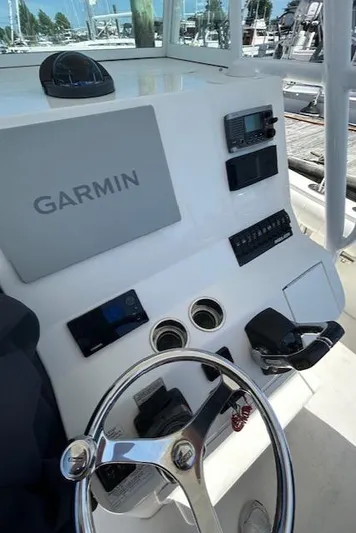  Yacht Photos Pics 2013 Regulator 26 FS boat dashboard with Garmin navigation system and steering wheel.