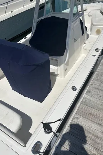  Yacht Photos Pics 2013 Regulator 26 FS boat with blue covers docked at marina.