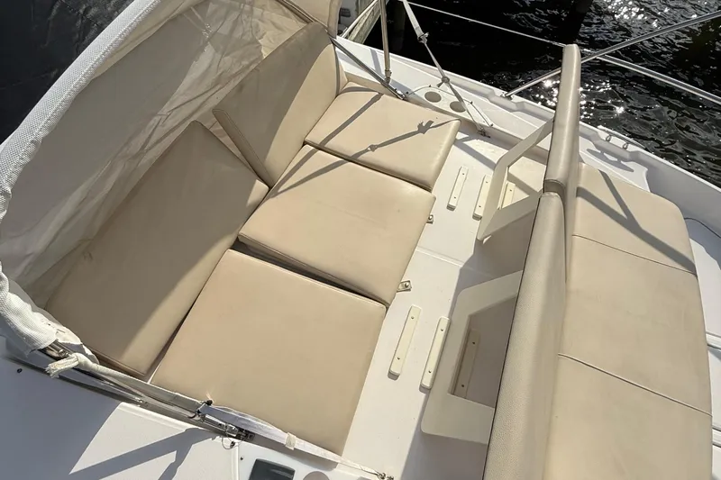 Tomtanic Yacht Photos Pics Luxurious seating on 2019 Regal 42 Fly yacht, featuring beige cushions and sleek design.