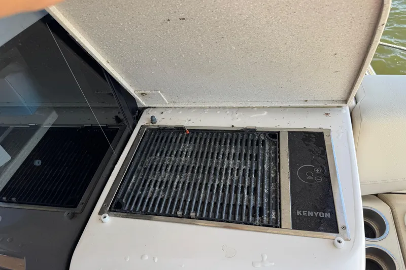 Tomtanic Yacht Photos Pics Kenyon grill on 2019 Regal 42 Fly yacht, open lid, near water.
