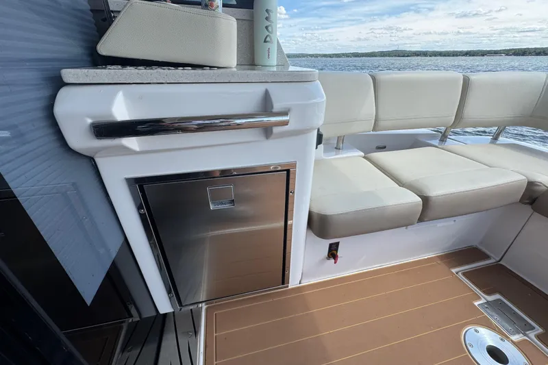 Tomtanic Yacht Photos Pics Luxurious 2019 Regal 42 Fly yacht interior with seating and mini fridge.