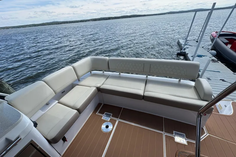 Tomtanic Yacht Photos Pics Luxurious seating area on a 2019 Regal 42 Fly yacht, overlooking serene waters.