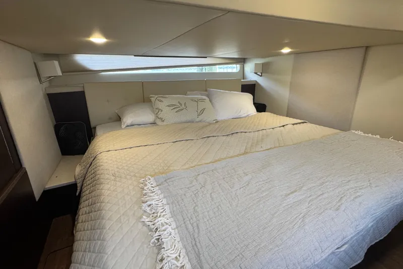 Tomtanic Yacht Photos Pics Luxurious bedroom interior of 2019 Regal 42 Fly yacht with cozy bedding.