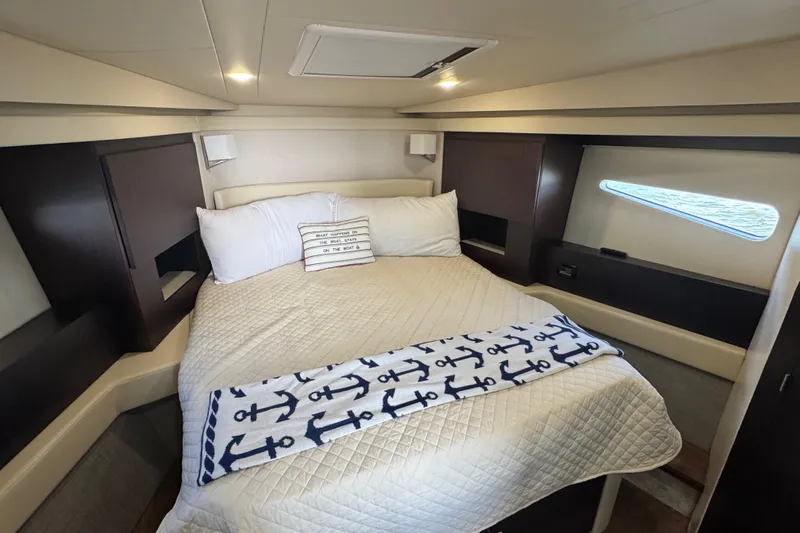 Tomtanic Yacht Photos Pics Luxurious cabin interior of 2019 Regal 42 Fly yacht with cozy bedding and nautical decor.