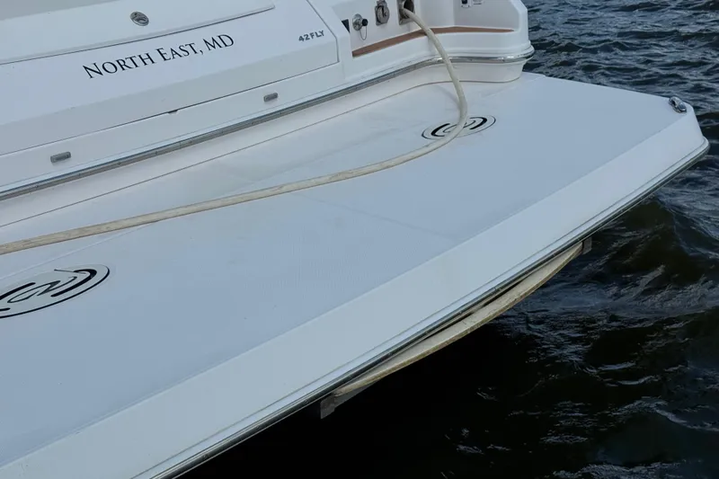 Tomtanic Yacht Photos Pics 2019 Regal 42 Fly yacht stern with North East, MD marking on water.