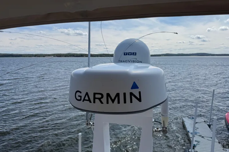 Tomtanic Yacht Photos Pics Garmin and TracVision equipment on 2019 Regal 42 Fly yacht, overlooking serene water.