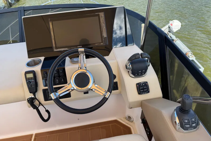 Tomtanic Yacht Photos Pics Steering console of 2019 Regal 42 Fly yacht with modern controls and navigation display.