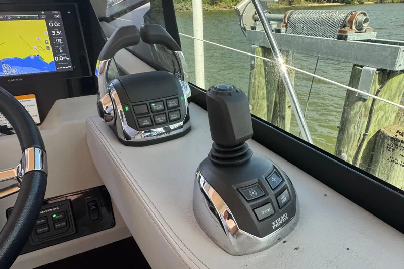 Tomtanic Yacht Photos Pics Control panel of a 2019 Regal 42 Fly yacht with navigation display and joystick.