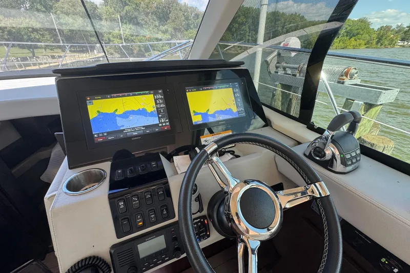 Tomtanic Yacht Photos Pics 2019 Regal 42 Fly yacht helm with navigation screens and steering wheel.