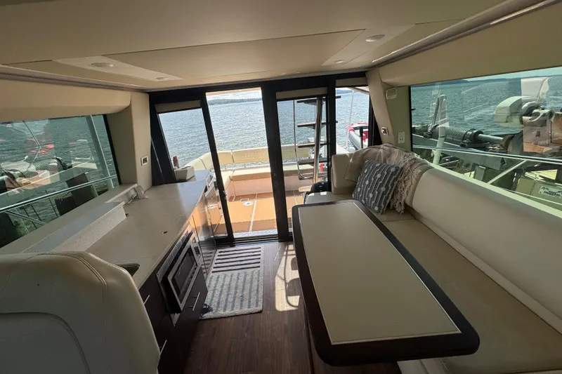 Tomtanic Yacht Photos Pics Luxurious interior of 2019 Regal 42 Fly yacht with modern kitchen and seating area.