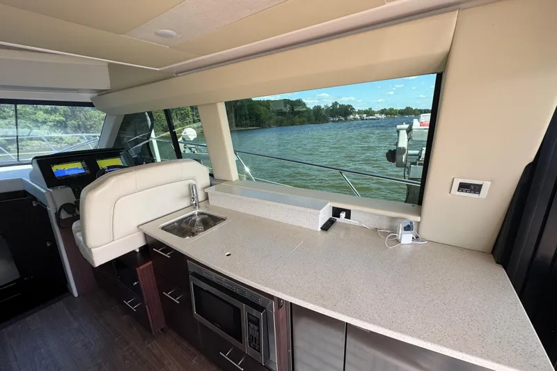 Tomtanic Yacht Photos Pics Luxurious interior of 2019 Regal 42 Fly yacht with kitchenette and scenic water view.